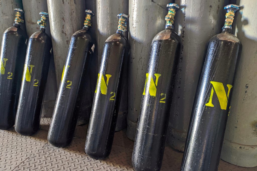 Nitrogen gas cylinders. Seamless steel industrial gas cylinders. Industrial steel bottles in line.